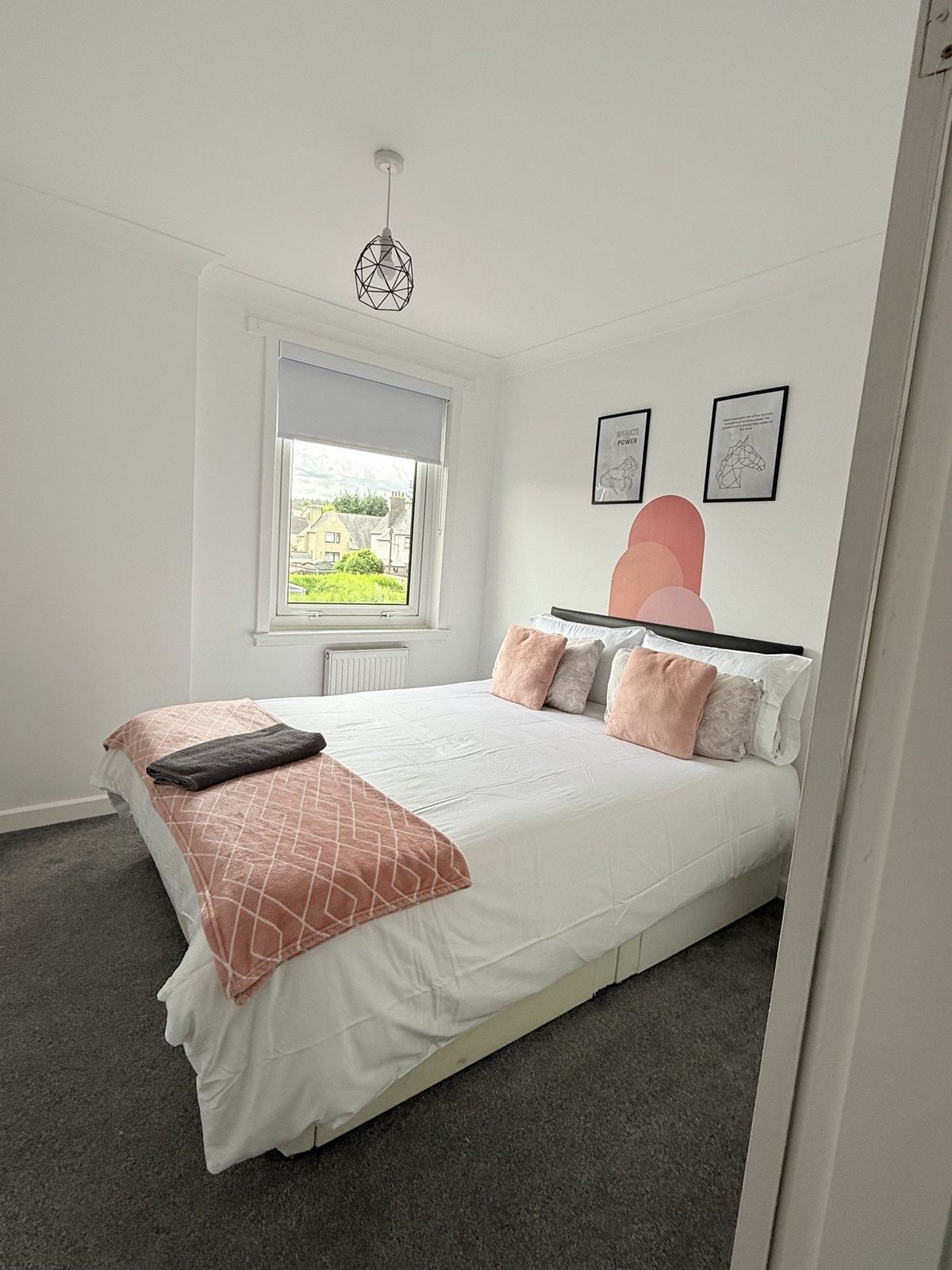 Power Room — super-king bed, daytime light, view of the street