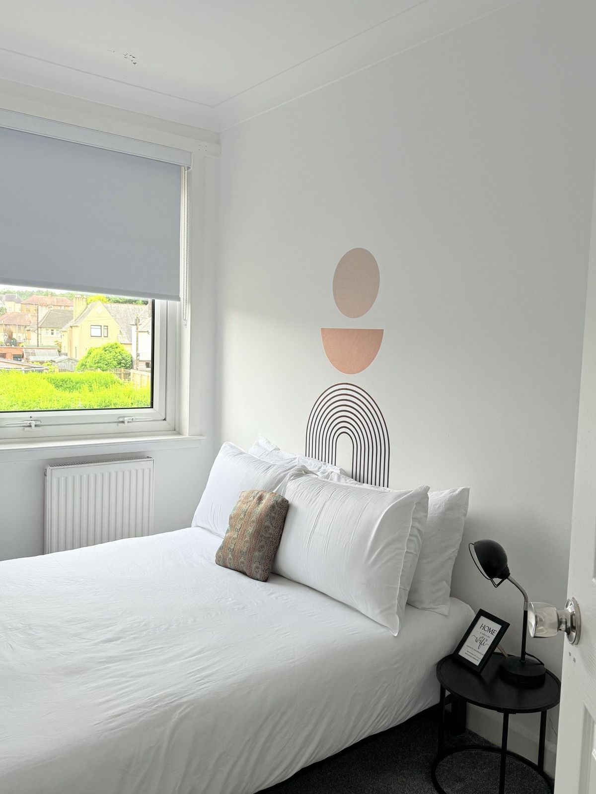 Fifth Bedroom — double bed, daytime light, view of the street